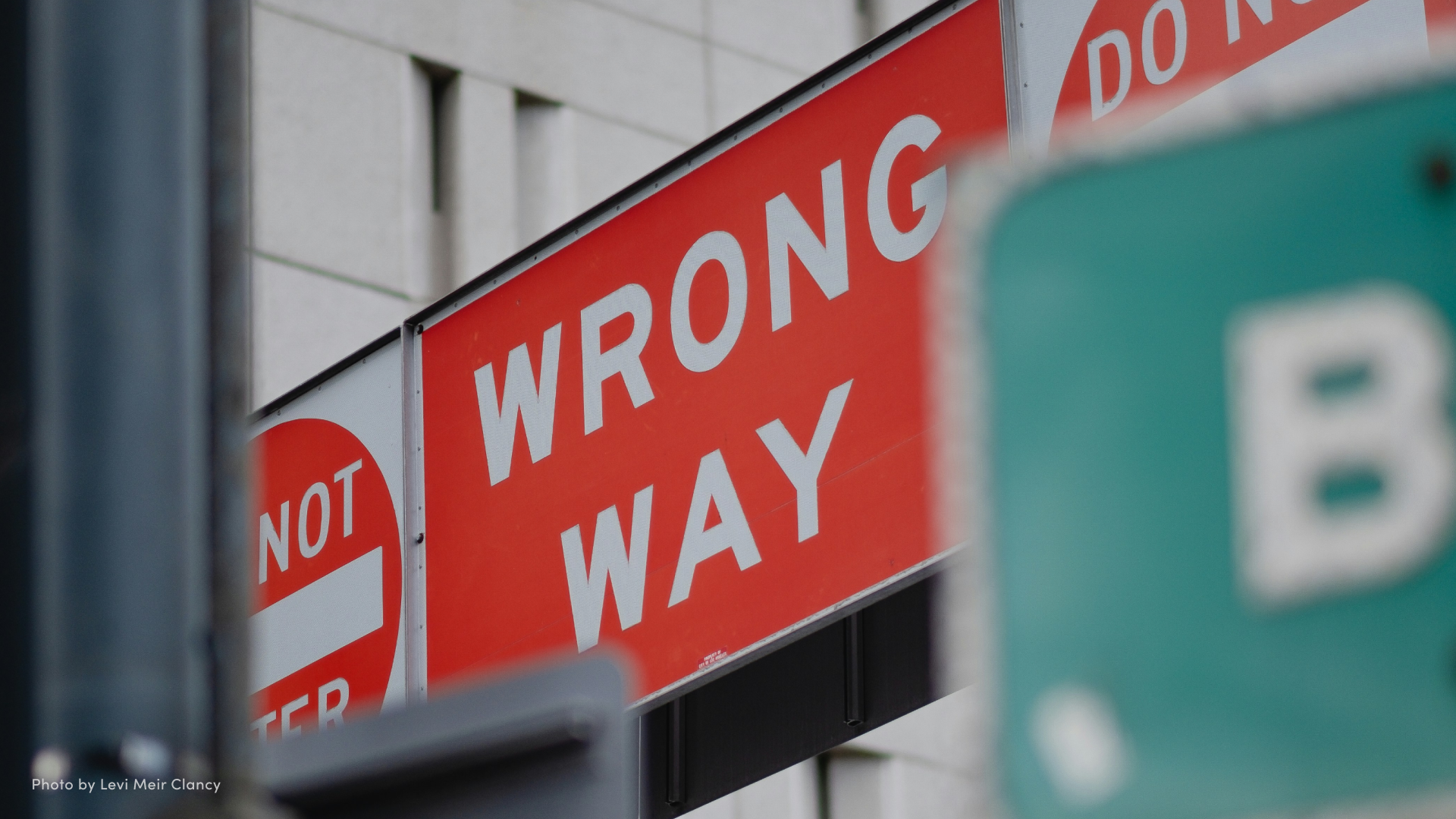 Assortment of directional street signs that read "Wrong Way" and "Do Not Enter."